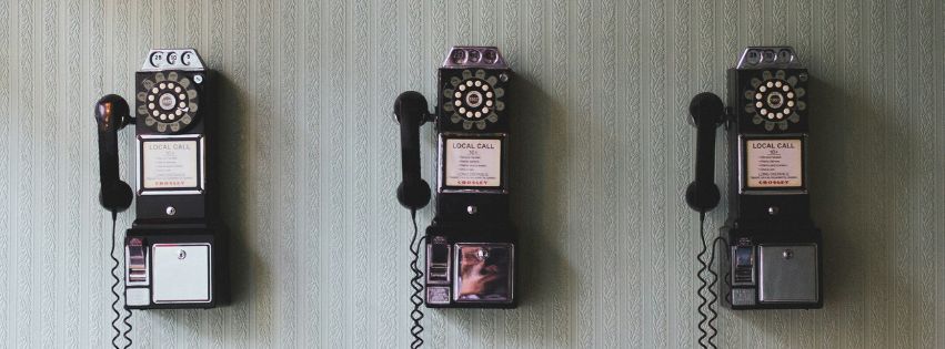 3 payphones on a wall