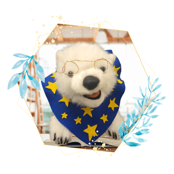 Vanilla, a polar bear, sitting on a book in a frame 