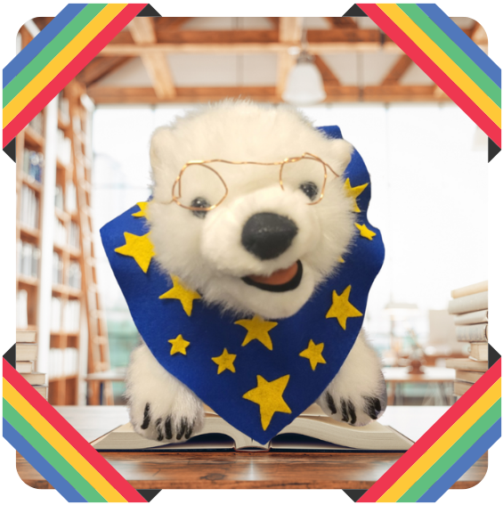 Vanilla, a polar bear, sitting on a book in a frame 