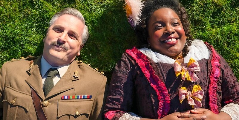 Captain and Kitty lie on the grass