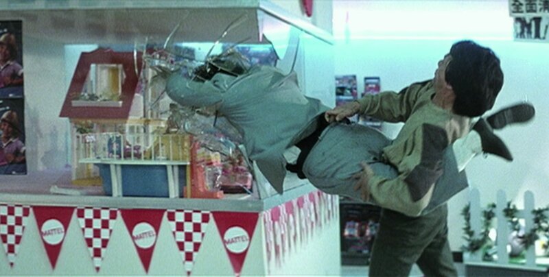 Jackie Chan throws a henchman through some glass