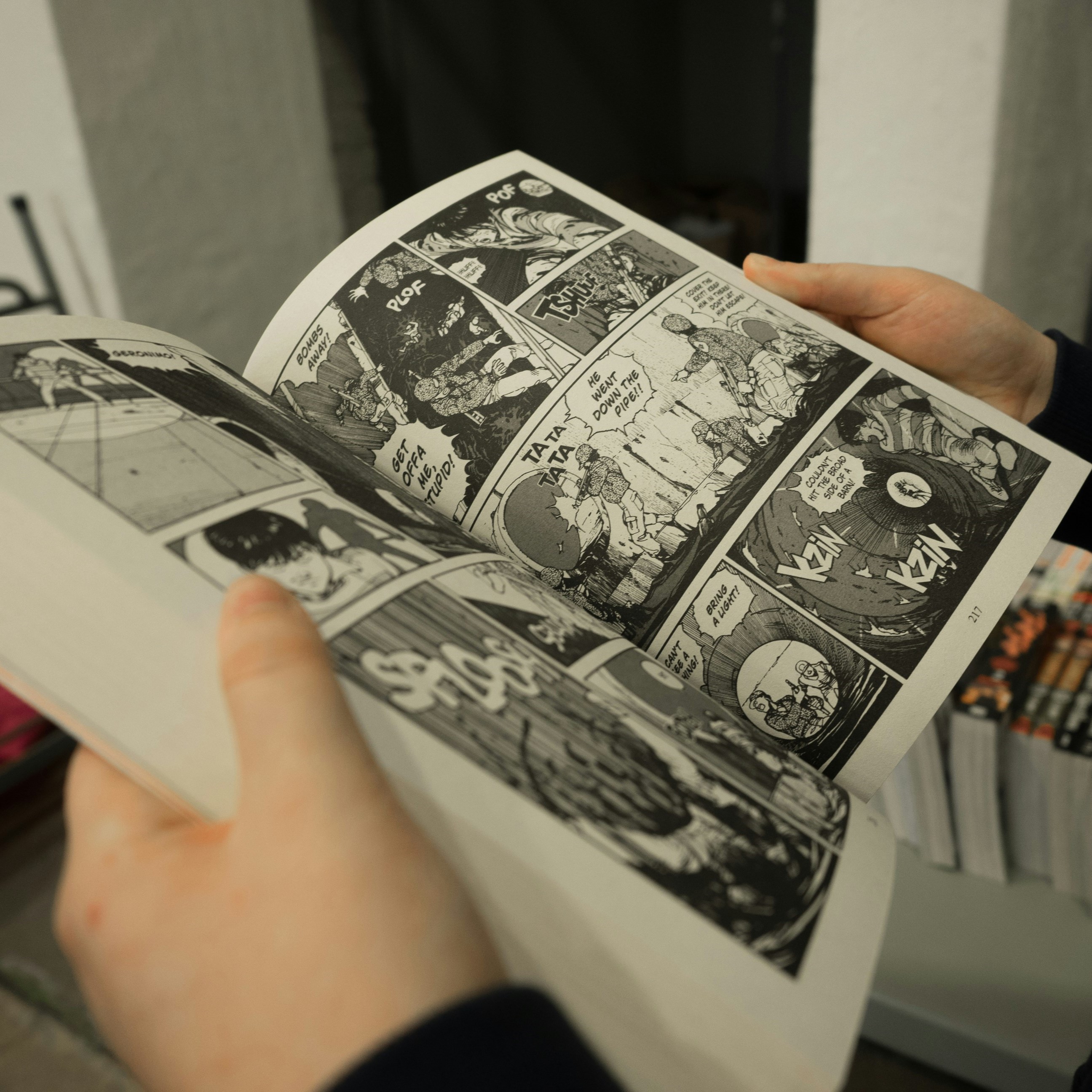 a scene of a physical manga book opened