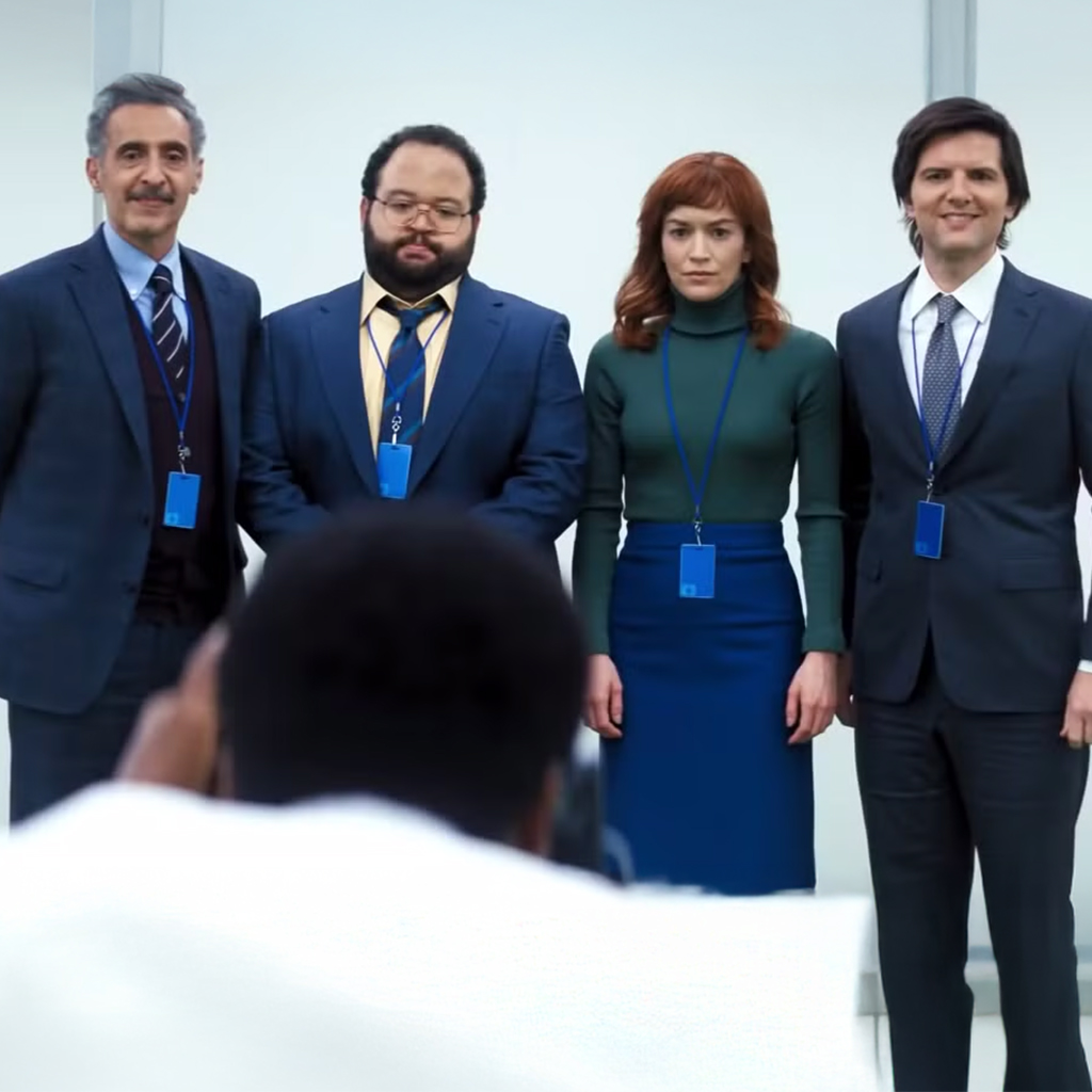 4 adults in a line wearing business clothing