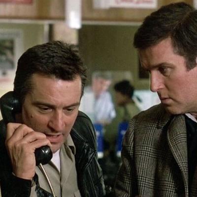 Robert De Niro makes a call while Charles Grodin looks on