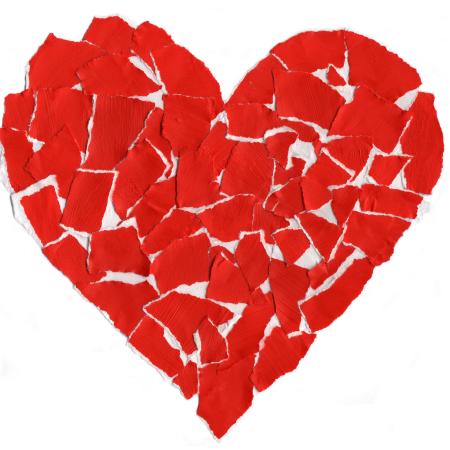 A red heart that has been ripped up and the pieces put back together