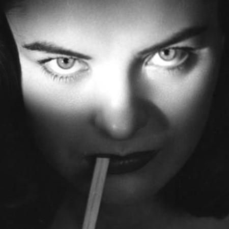 Ella Raines in closeup with cigarette
